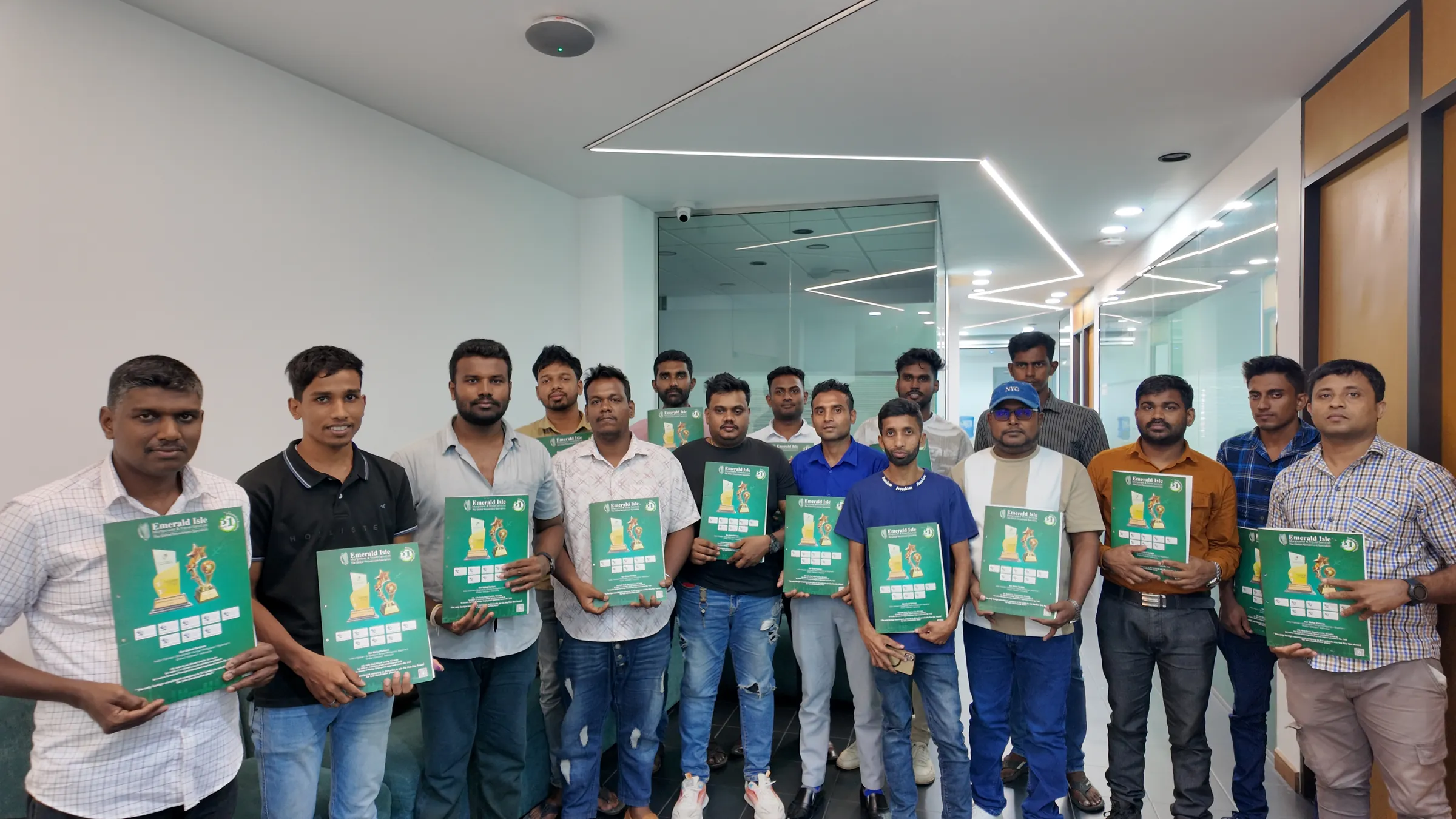 A group of candidates holding Emerald Isle folders at the office
